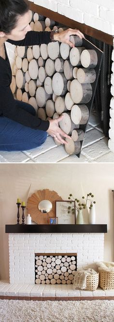 a woman sitting on the floor next to a fire place with logs in front of it