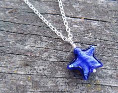 "Offered for moms who have sons or daughters in the military is our BLUE STAR MOM necklace! This was my beloved Dad's idea who retired as Command Sergeant Major from the US Army, and passed 9 months ago. I never would have known about Blue Star moms if not for him. The blue star is hand made by glass artists in Venice, Italy (Murano glass / Venetian glass), and it's small (1/2\" across). Please refer to the fourth photo to get a sense of size. Using the drop down menu, you may add an initial cha Blue Star-shaped Nickel-free Necklace, Blue Star Shaped Necklace For Gift, Blue Star Charm Necklace As Gift, Blue Star Charm Necklace As A Gift, Blue Star Charm Necklace For Gift, Blue Star Of David Necklace Gift, Blue Sterling Silver Necklace With Star Charm, Blue Star Of David Necklace As Gift, Blue Necklace With Star Charm As A Gift