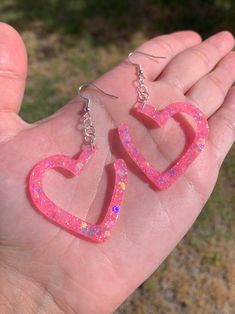 "Each pair of resin earrings are handmade to order, therefore no two pairs are identical! However, I try to get as close as possible :) Made with nickel free, hypoallergenic, sterling silver plated fishhooks.  Heart width and height is approximately 1.5\"x1.5\", and is made with epoxy resin and light pink chunky holographic mix glitter 💖  UV Blacklight reactive!   Thanks for visiting my shop! ✨" Resin Heart Earrings For Gifts, Pink Resin Heart Earrings For Gift, Pink Resin Heart Earrings As Gift, Pink Heart Resin Earrings, Cute Resin Heart Earrings For Valentine's Day, Pink Resin Heart Earrings Handmade, Pink Resin Heart Earrings, Handmade Pink Resin Heart Earrings, Handmade Pink Heart Earrings In Resin