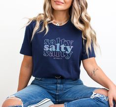 This Salty Shirt makes a wonderful gift for Christmas, a Church Event, a Church Retreat, a Christian Beach Trip, and more! Product Information ▸ Bella+Canvas brand shirt that is durable, soft, stylish, and made in an ecofriendly process ▸ Solid colors are 100% Airlume combed and ringspun cotton ▸ Heather colors are 52% Airlume combed and ring-spun cotton, 48% poly ▸ This is a Direct-to-Garment (DTG) printed item where the ink of the design is printed onto the item ▸ Rolled sleeves in pictures ar Blue Crew Neck Top For Holiday, Casual Pre-shrunk Holiday T-shirt, Casual Pre-shrunk T-shirt For Holiday, Casual Cotton Tops For Holiday, Casual Relaxed Fit Tops For Holiday, Casual Letter Print Tops For Holiday, Casual Letter Print Shirt For Holiday, Christian Funny, Church Retreat