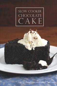 a piece of chocolate cake with whipped cream on top is sitting on a white plate