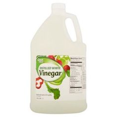 a gallon bottle of vinegar on a white background with the label labeled, bottled white vinegar