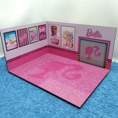 a barbie doll's room with pink carpet and pictures on the wall