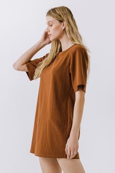 This Shoulder Pad T-Shirt Dress is a wardrobe must-have! Featuring a stylish round neckline, short sleeves, and a boxy silhouette, it's the perfect addition to any outfit. Our unique shoulder pad insert adds structure and a touch of sass, making this dress a standout. With its comfortable fit and comfortability, you'll look amazing no matter what the occasion. Show off your fashion-forward style with this shoulder-pad t-shirt dress! Shoulder pad inserted Round neckline Short sleeves Boxy silhoue Brown Oversized Short Sleeve Dress, Oversized Short Sleeve T-shirt Dress, Relaxed Fit Short Sleeve T-shirt Dress For Fall, Short Sleeve Everyday Fall Dresses, Everyday Short Sleeve Fall Dresses, Solid Color Short Sleeve Everyday Dresses, Everyday Solid Color Dress With Short Sleeves, Jumpsuit Fall, Blazer And Shorts