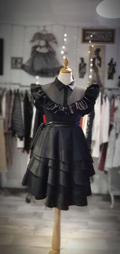 Wednesday Addams wednesday dress (TV series) in: 🖤 French Duchess satin fabrics for the collar and the button tab. 🖤 Front and transparent back in French chiffon. 🖤 Ruffles of the top and the ruffles of the skirt in satin silk and black tulle. 🖤Three functional buttons on the front. 🖤Closure on the side seam. 🖤 leather belt. 🖤 size of the model in the photos is in size 36. 🖤 100% handmade dress. 📌FIT & SIZING ☆ The dress measures 106 cm, the model wears size S. Please find item measurem Addams Wednesday, Wednesday Addams Cosplay, Wednesday Dress, Satin Fabrics, Duchess Satin, French Fabric, Handmade Dress, Black Tulle, Chiffon Ruffle