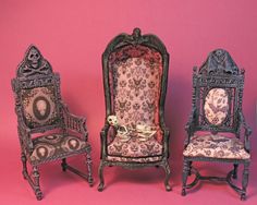 three miniature chairs and a clock on a pink background