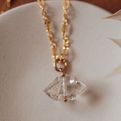 The Herkimer diamond drop necklace is the perfect combo of dainty and sparkly. Our popular Mia chain is adorned with a hand wire wrapped Herkimer diamond crystal. Herkimer diamonds are beautiful double-terminated quartz crystals found in Herkimer, New York. The quartz crystals you receive will vary in size (10-12mm) an Elegant Herkimer Diamond Crystal Necklace Gift, Elegant Herkimer Diamond Crystal Necklaces For Gifts, Faceted Crystal Dangle Necklaces For Gifts, Clear Quartz Necklaces For Jewelry Making, Elegant Faceted Herkimer Diamond Jewelry, Clear Jewelry With Adjustable Chain For Jewelry Making, Faceted Briolette Crystal Jewelry, Elegant Clear Quartz Crystal Necklace, Elegant Crystal Necklace With Wire Wrapped Detail