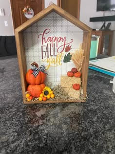 a small house made out of hay and pumpkins