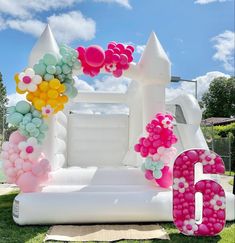 an inflatable castle is decorated with balloons