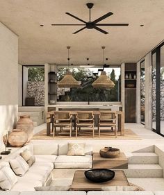 a living room filled with lots of furniture next to a dining table and two lamps