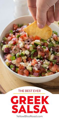 a hand dipping a tortilla chip into a bowl of greek salsa with the words, the best ever