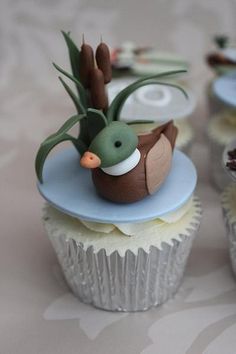 several cupcakes with frosting and decorations on them