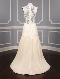 a wedding dress on display in a room