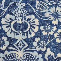 a blue and white fabric with flowers on the front, in an ornate pattern that is very