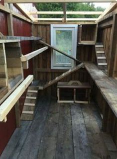 the inside of a chicken coop with wooden floors