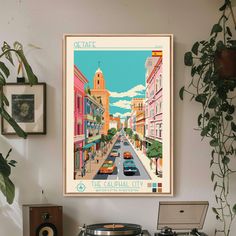 a record player sitting on top of a table in front of a wall mounted poster