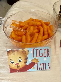 there is a bowl full of cheetos and a sign with tiger tails on it