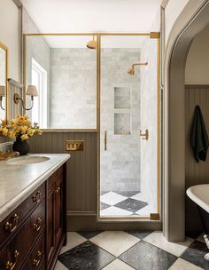 a bath room with a tub a sink and a mirror on the wall in it