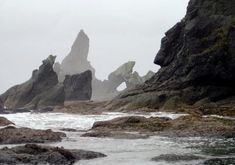 some rocks and water on a cloudy day