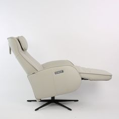 a white recliner chair sitting on top of a black base