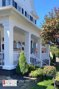 a white house with black shutters on the front porch