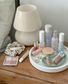 a wooden table topped with lots of cosmetics and personal care items on top of it