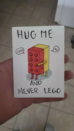 someone is holding up a card that says hug me and never lego