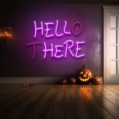 there is a neon sign that says hello there with pumpkins in front of it