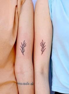 two people with matching tattoos on their arms