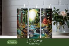 three candles with the image of a forest and waterfall on them are shown in front of a white brick wall