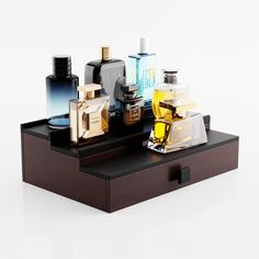 an assortment of perfumes and cologne bottles on a tray