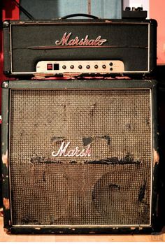 an old amp sitting on top of a wooden floor