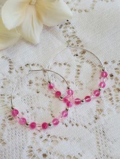 These lovely hoop earrings are the perfect touch to any outfit, as well  as super lightweight and so much fun to wear! Made with silver, bright pink and pink. Hoop measures 1.5 inches. Pink Beaded Hoop Jewelry, Handmade Pink Hoop Earrings, Trendy Pink Hoop Earrings With Round Beads, Pink Beaded Small Hoop Jewelry, Handmade Pink Hoop Jewelry, Handmade Pink Hoop Earrings Gift, Pink Round Beads Earrings Nickel Free, Pink Nickel-free Round Beaded Earrings, Pink Nickel-free Round Bead Earrings