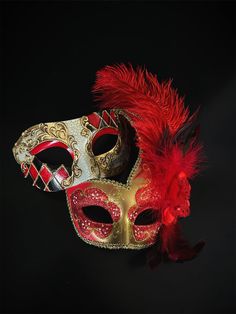 Couple's elegant Venetian masquerade mask set in red and gold. Adorned with red lush feathers, the women's mask exudes a sense of opulence that will leave admirers enchanted. The men's half-face phantom mask captures the essence of mystery and intrigue. The matching set ensures you and your partner complement each other beautifully, making the night extra special.   Age Group/Gender - Adult/Unisex  Size/Type - One size fits all adults  Mask Color - Red/Gold  Mask Material - Polyresin  Accent Mat Red Mask Masquerade, Red Masquerade, Phantom Mask, Couples Masquerade Masks, Masquerade Theme, Venetian Masquerade Masks, Red Mask, Female Mask, Venetian Masquerade