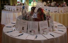 the table is set up with many items for sale and there are cards on it