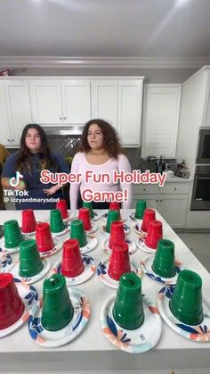 two women sitting at a kitchen table with cups and saucers in front of them