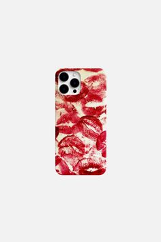 a red and white phone case with lipstick prints on the back, in front of a white background