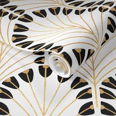 a white and gold wallpaper with black and gold leaves on the side, as well as an abstract design