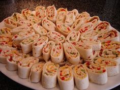 a platter filled with lots of different types of food on top of a table