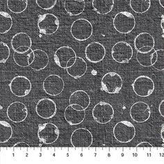 a black and white photo with lots of circles on the fabric, as well as numbers