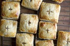 several square pastries sitting on top of a cooling rack