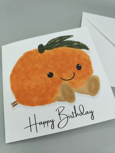 a happy birthday card with an orange on it