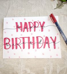 a birthday card with the words happy birthday written on it and a pen next to it