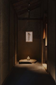 a dimly lit room with a cross on the wall