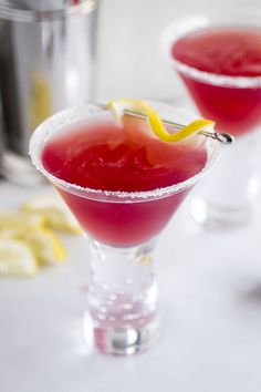 two glasses filled with watermelon and lemonade sit on a white counter top