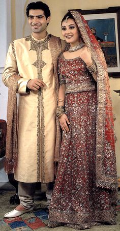 two people standing next to each other in wedding outfits