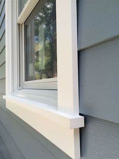 a close up of a window on the side of a house with siding and windows