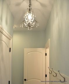 an image of a hallway with a chandelier hanging from it's ceiling