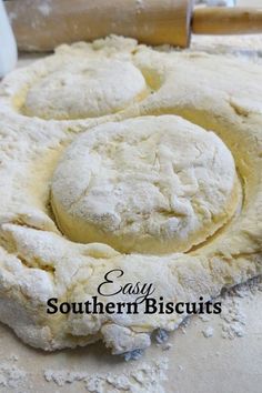 dough is being made on a table with a rolling pin next to it and the words easy southern biscuits written in large letters