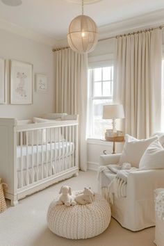 a baby's room with white furniture and decor